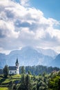 Church Cerkev Sveti Duh with mountain range KamnikÃ¢â¬âSavinja Alps Royalty Free Stock Photo